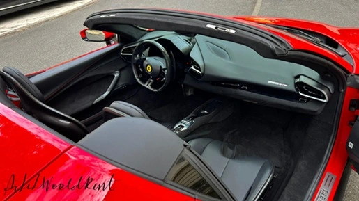 red convertible ferrari 296 spider with open roof in red color with black interior